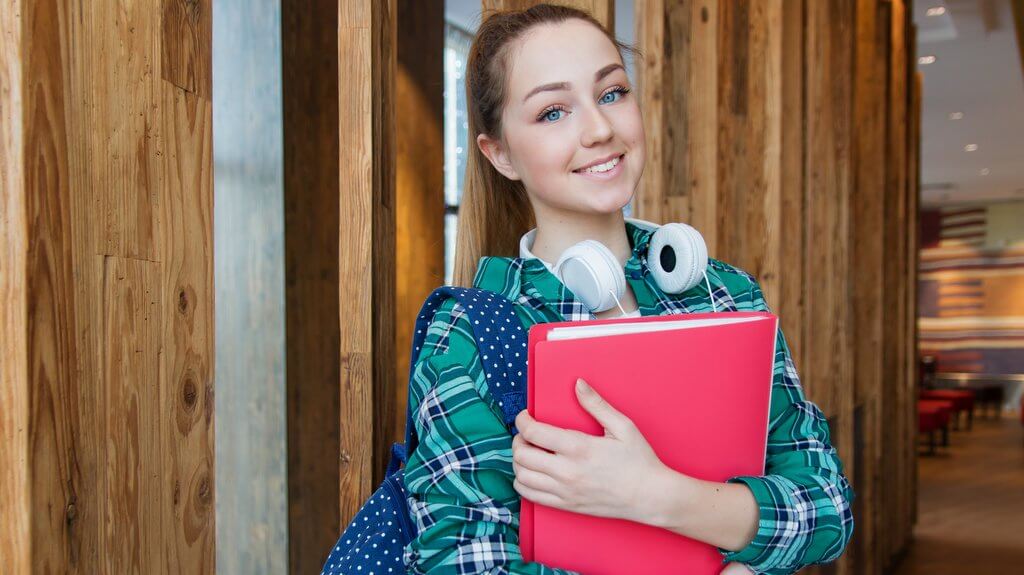 Image of a girl carrying a book